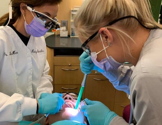 Dental assisting student training one on one with instructor