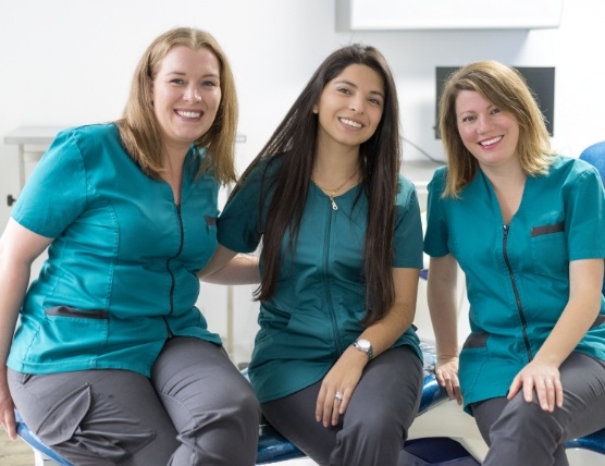 Three smiling dental assistants
