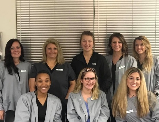 Smiling group of certified dental assistants