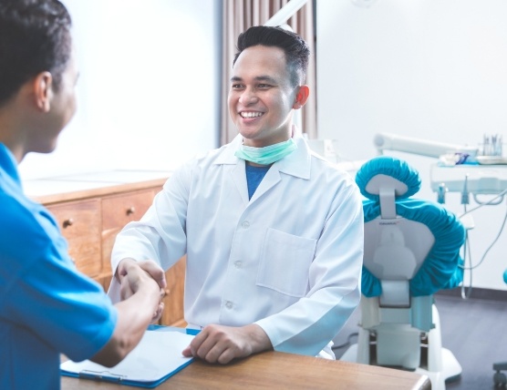 Dental consultant shaking hands with dentist