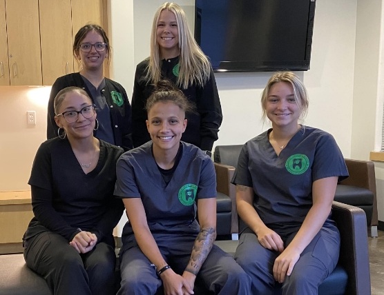 Five smiling dental assisting students