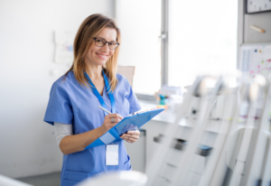 a dental assistant holding a clipboard 