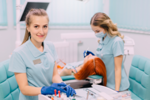 a pair of dental assistants smiling 