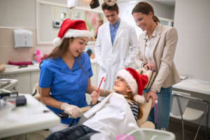 a dental assistant treating a child during the holidays