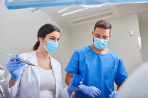 a pair of dental assistants smiling and chatting